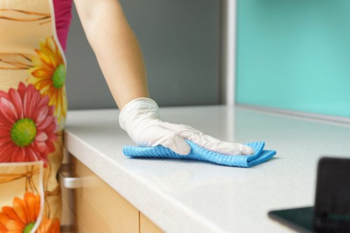 Deep cleaning kitchen surfaces during a Pimlico move out service